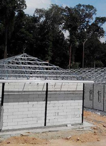 A Thung Hing's government project in Kem PLKN, Ayer Keroh, showcasing TH C-Purlin galvanized steel roof framing on a building under construction.