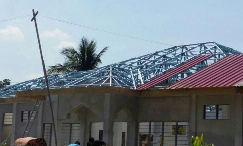 Thung Hing's healthcare project in Kemaman Hospital, Terengganu, showcasing TH C-Purlin galvanized steel roof framing on a partially completed building with red roof.